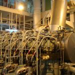 What is the construction of a marine diesel engine piston used on board ships?