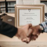 Selective focus photo of a diploma on a frame